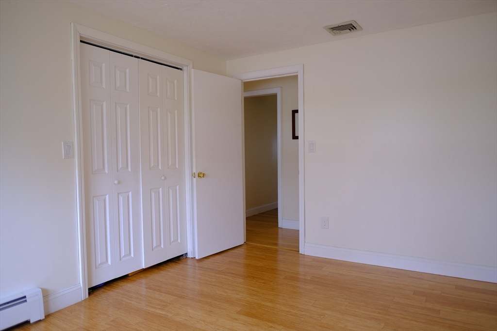 9 Stanley Street Natick, MA 01760 - Photo 30 of 42 a view of an empty room with wooden floor