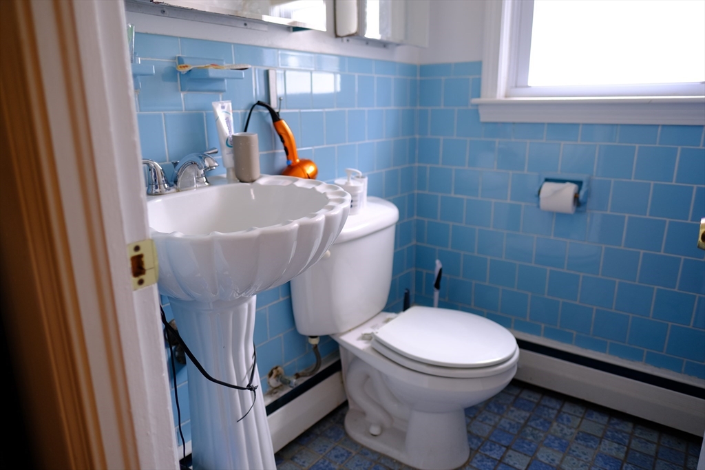 9 Stanley Street Natick, MA 01760 - Photo 33 of 42 a bathroom with a sink and a toilet