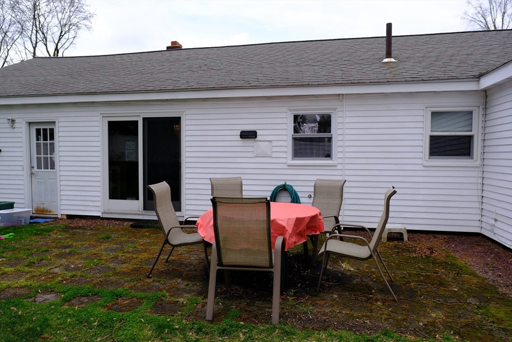 9 Stanley Street Natick, MA 01760 - Photo 9 of 42 a backyard of a house with table and chairs