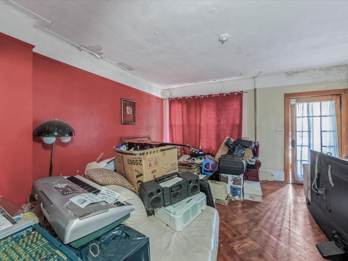 1775 Troy Avenue Brooklyn, NY 11234 - Photo 4 of 17 a living room with furniture a rug and a window