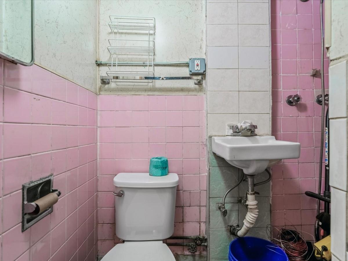 1775 Troy Avenue Brooklyn, NY 11234 - Photo 9 of 17 a bathroom with a sink toilet and a mirror