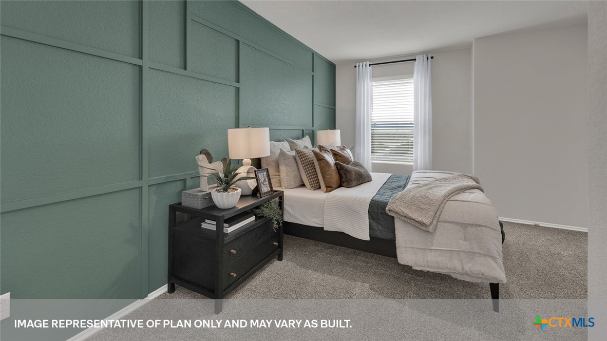 125 Kendall Lane Lockhart, TX 78644 - Photo 16 of 30 a bedroom with a bed and dresser with mirror