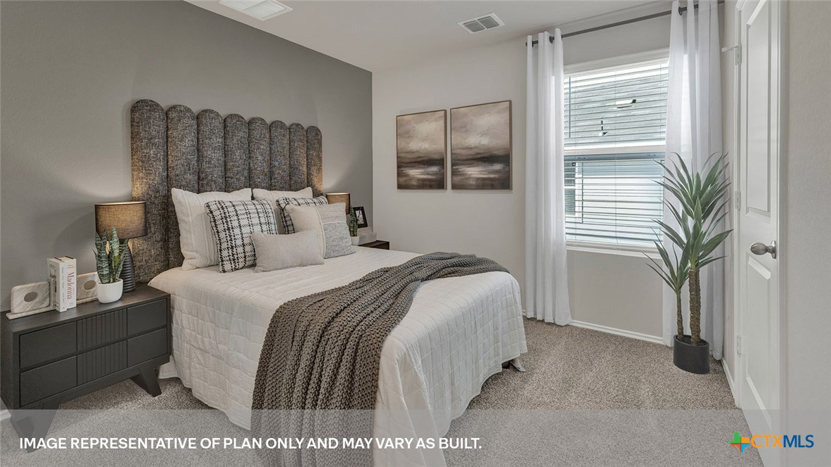 125 Kendall Lane Lockhart, TX 78644 - Photo 23 of 30 a bedroom with a bed and a window