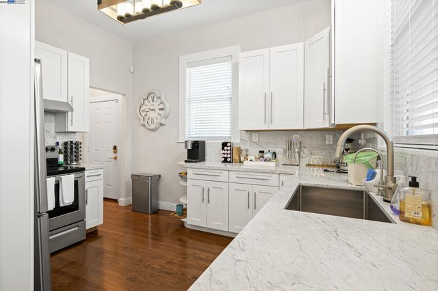 a kitchen with a sink cabinets and stainless steel appliances