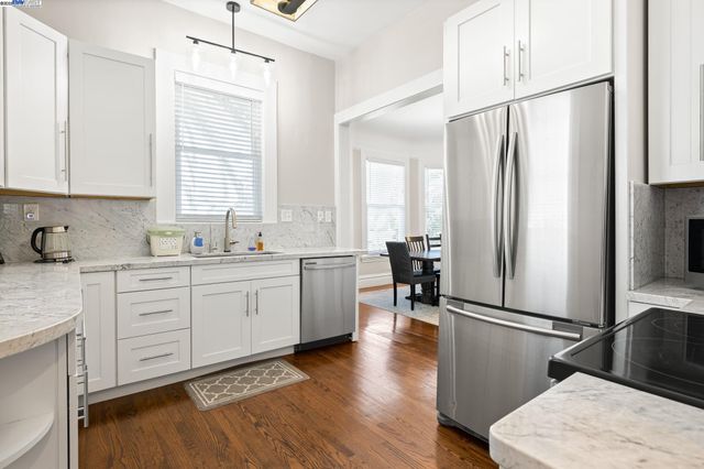 a kitchen with sink cabinets and wooden floor