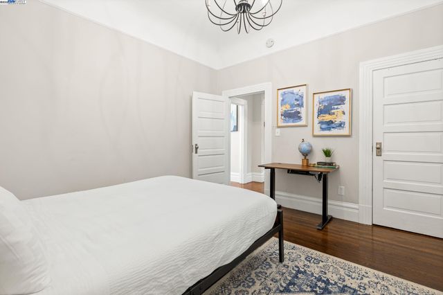 a bedroom with a bed table and a window