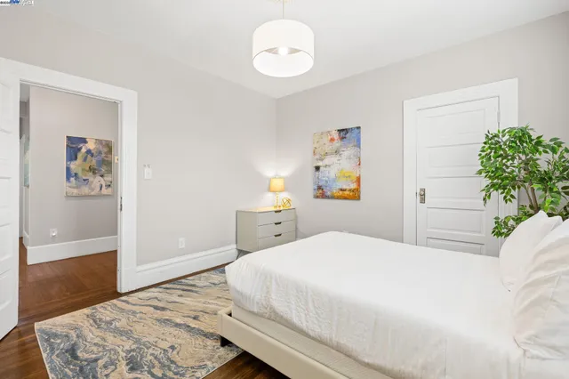 a bedroom with a bed and a chandelier