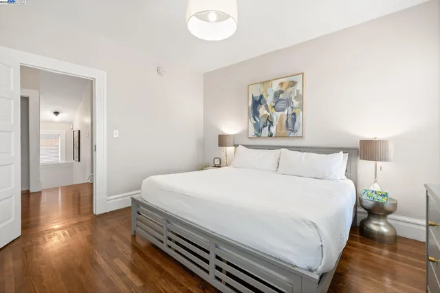 a bedroom with a large bed and a chandelier