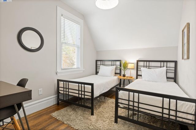 a bedroom with a bed a dresser and a window