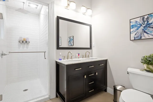 a bathroom with a toilet a sink and mirror