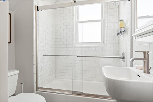 a white bath tub sitting next to a white toilet