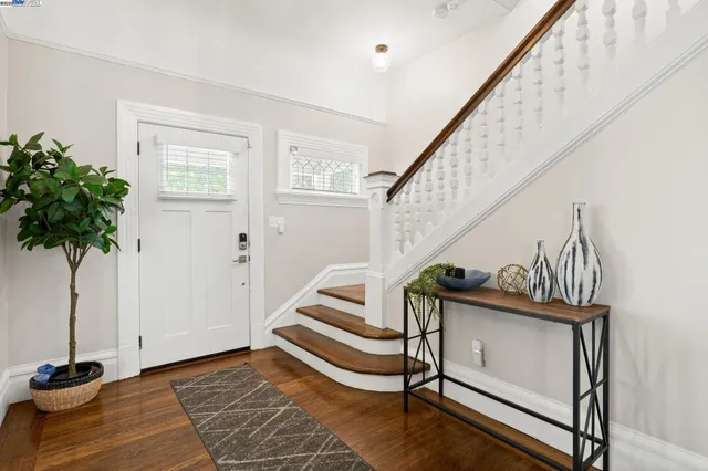 a view of entryway bedroom and hall with wooden floor