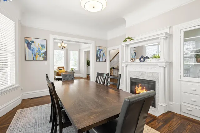 a dining room with furniture and wooden floor