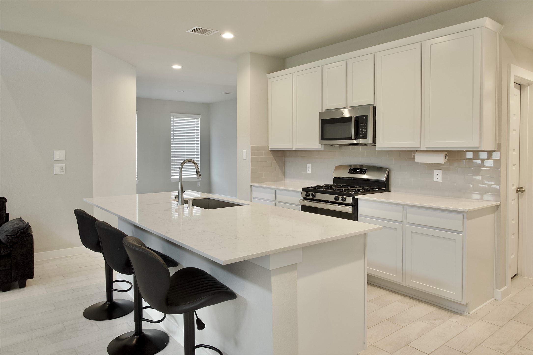 3207 Tilley Drive Rosenberg, TX 77471 - Photo 11 of 43 a kitchen with stainless steel appliances a table chairs sink and cabinets