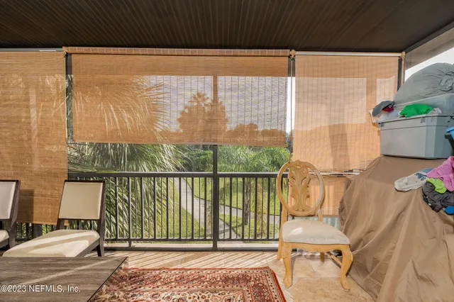 a balcony with table and chairs