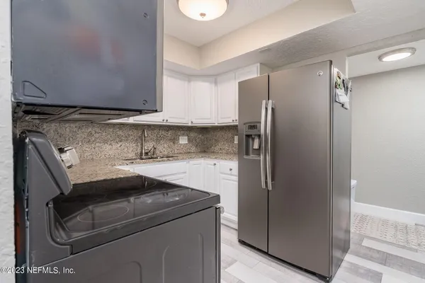 a kitchen with a refrigerator and cabinets