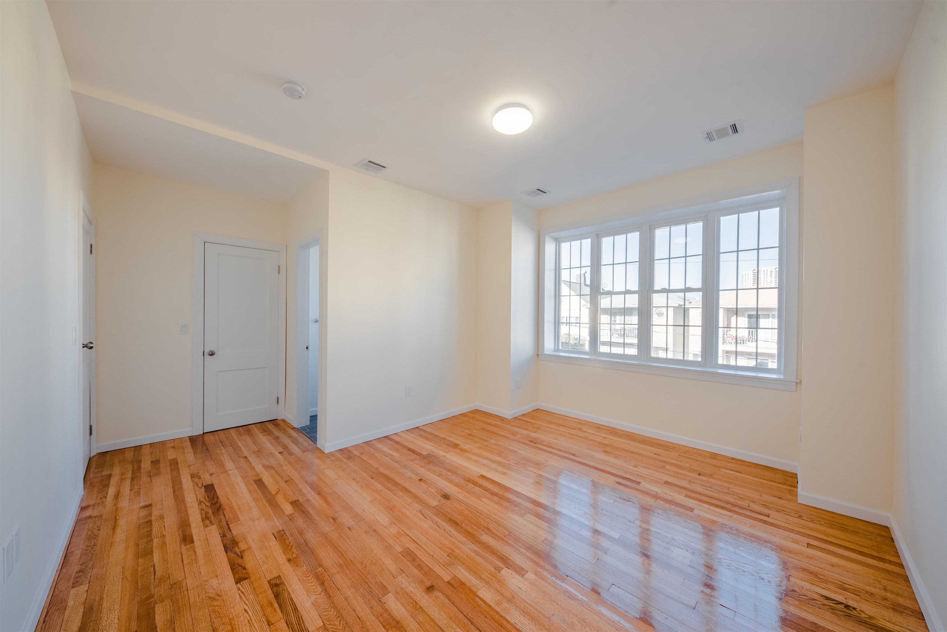 67 70th Street, Unit 2 Guttenberg, NJ 07093 - Photo 4 of 10 a bedroom with a bed and a window