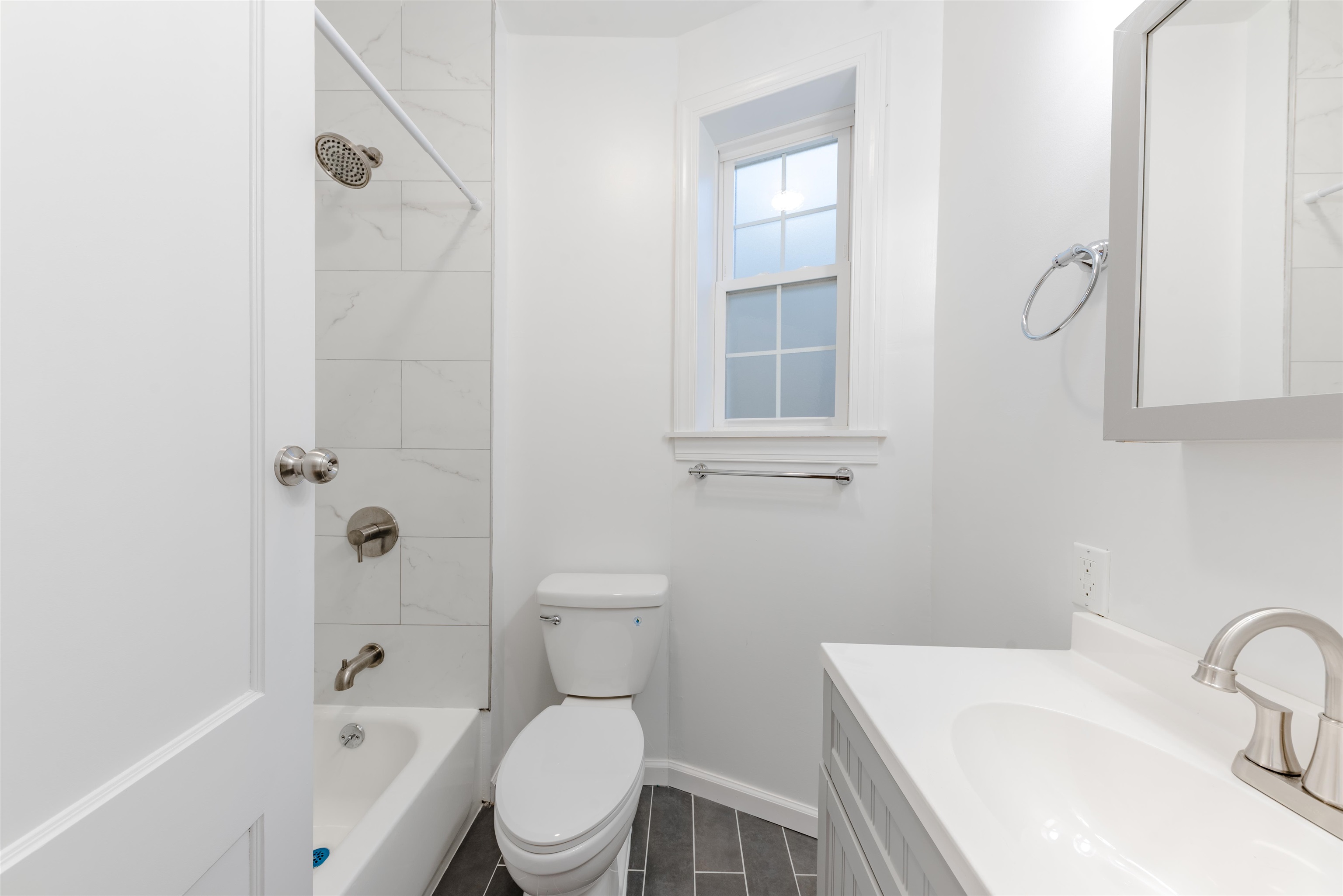 67 70th Street, Unit 2 Guttenberg, NJ 07093 - Photo 7 of 10 a white toilet sitting next to a bathroom sink