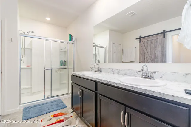 a bathroom with a double vanity sink and mirror