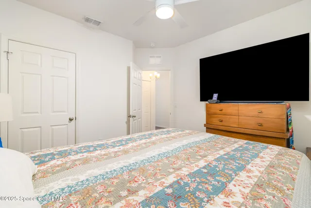 a bedroom with a bed and a television