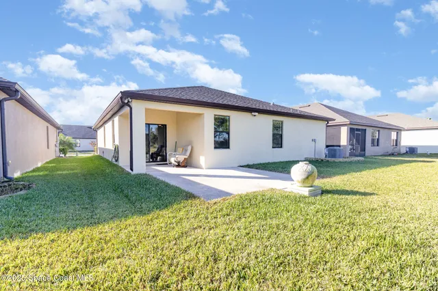 a view of a house with swimming pool and a yard