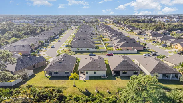 an aerial view of residential houses with outdoor space and swimming pool