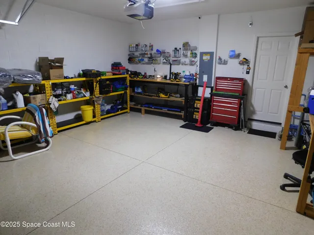 a view of a bedroom with baby crib and toys