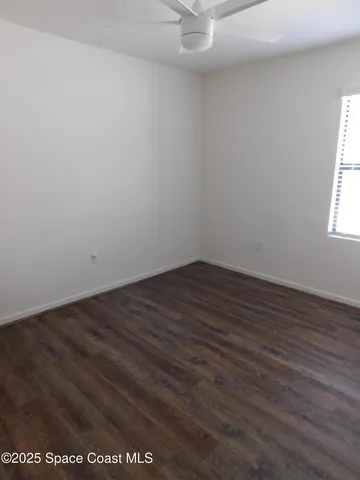 a bedroom with a bed and painting on the wall