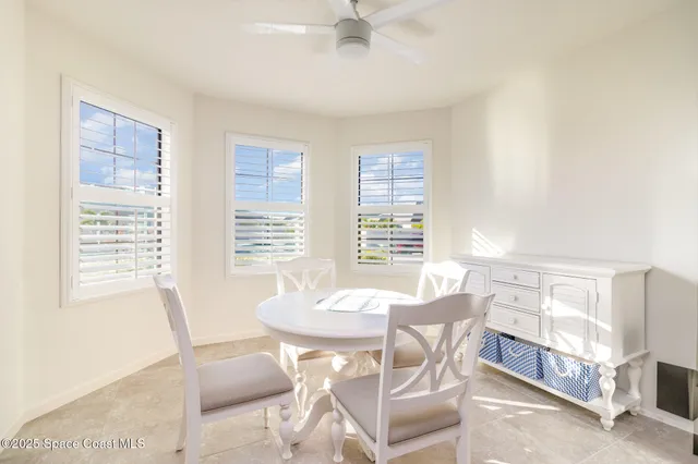 a view of a dining room with furniture and a window