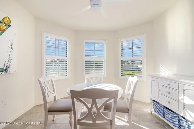 a view of a dining room with furniture and windows