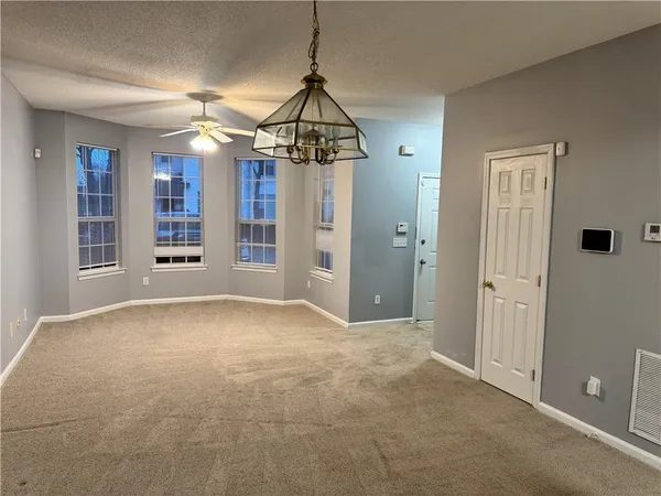 a view of a room with an empty space and a window