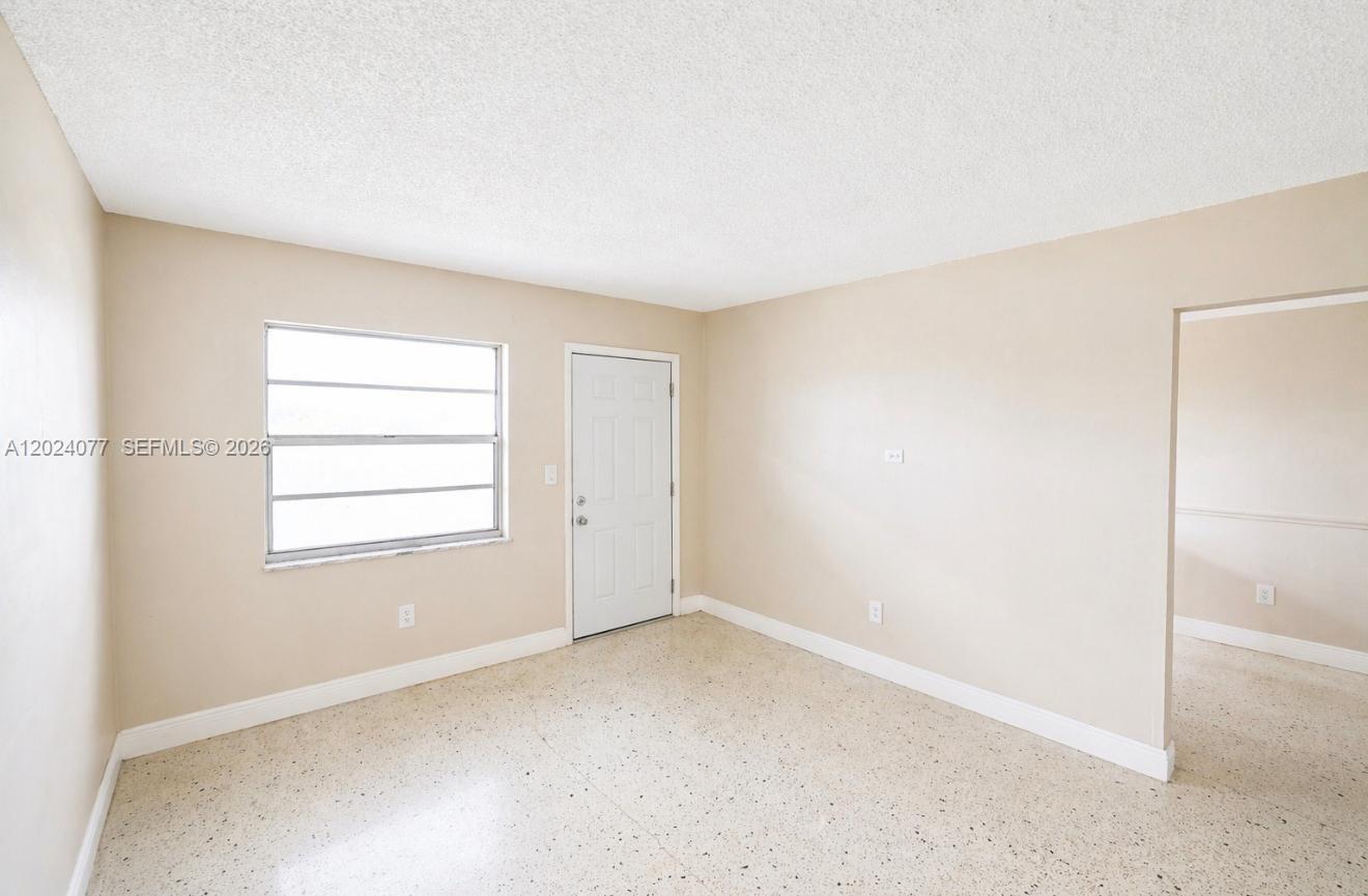 2315 West Okeechobee Road, Unit 304 Hialeah, FL 33010 - Photo 6 of 8 an empty room with a window