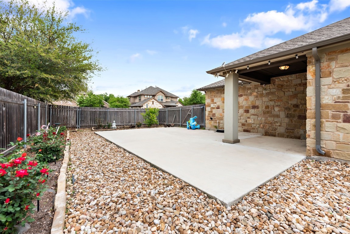 2000 Manada Trail Leander, TX 78641 - Photo 34 of 36 An inviting private yard with a large patio offers ample space for outdoor enjoyment and entertaining.