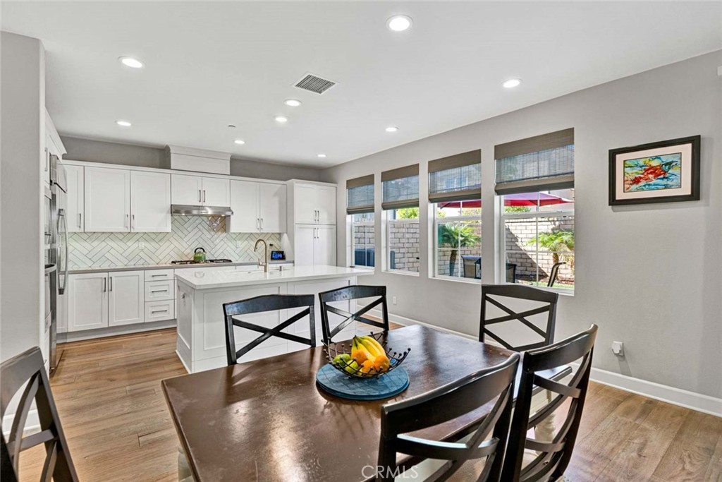 1270 Providence Loop Placentia, CA 92870 - Photo 17 of 59 Dining area with view of Center Island and Kitchen plus wall of windows to yard.