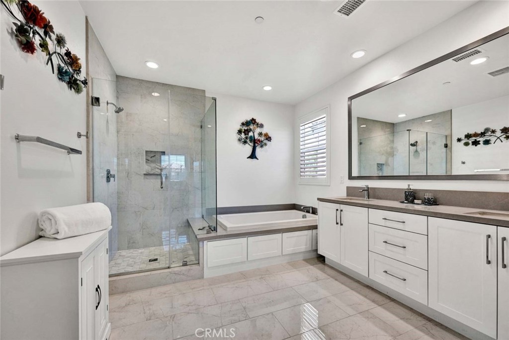 1270 Providence Loop Placentia, CA 92870 - Photo 34 of 59 a spacious bathroom with a double vanity sink a large mirror and a bathtub