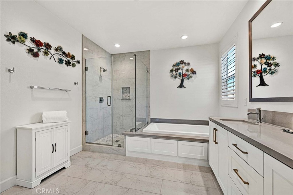 1270 Providence Loop Placentia, CA 92870 - Photo 35 of 59 a spacious bathroom with a double vanity sink a mirror and a bathtub