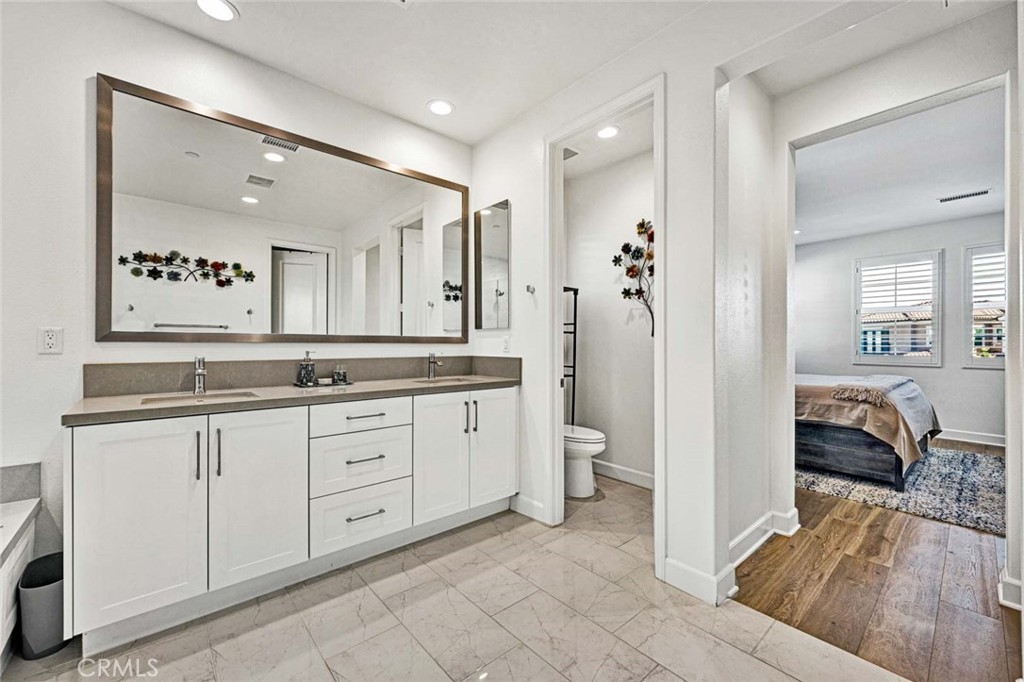 1270 Providence Loop Placentia, CA 92870 - Photo 36 of 59 a spacious bathroom with a granite countertop sink and a mirror