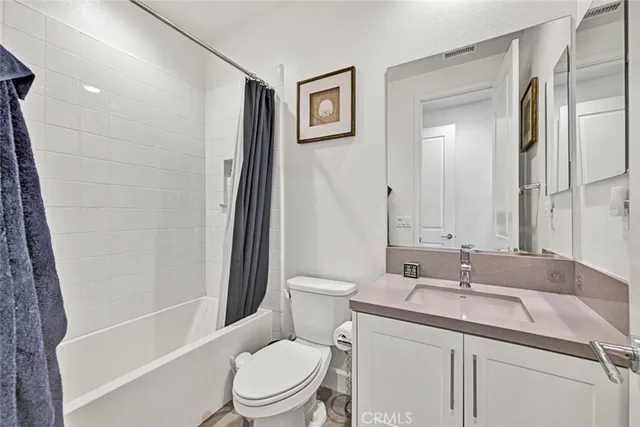 a view of a patio with table and chairs under an umbrella