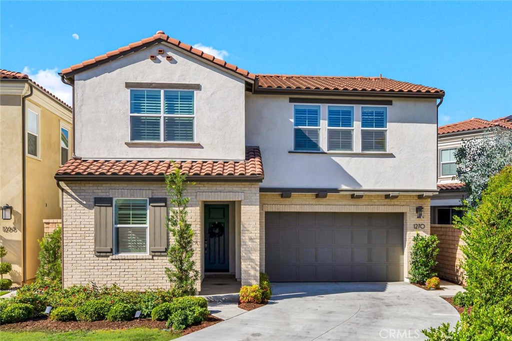 1270 Providence Loop Placentia, CA 92870 - Photo 4 of 59 a front view of a house with a yard and garage