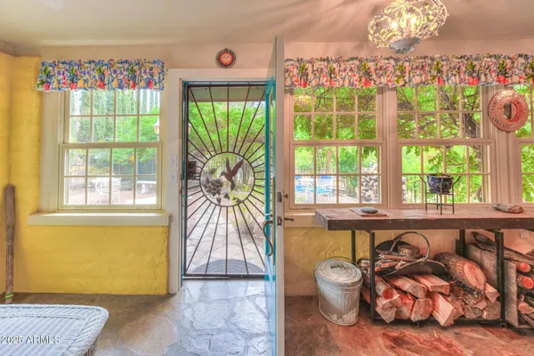 a living room with fireplace furniture and a large window