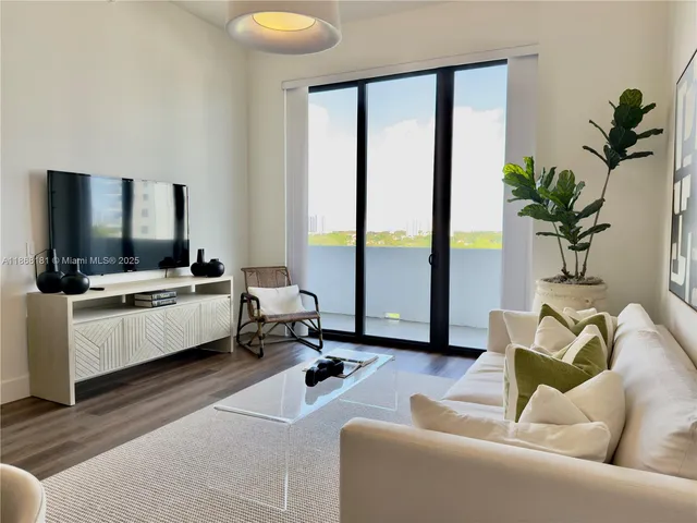 a living room with furniture and large windows