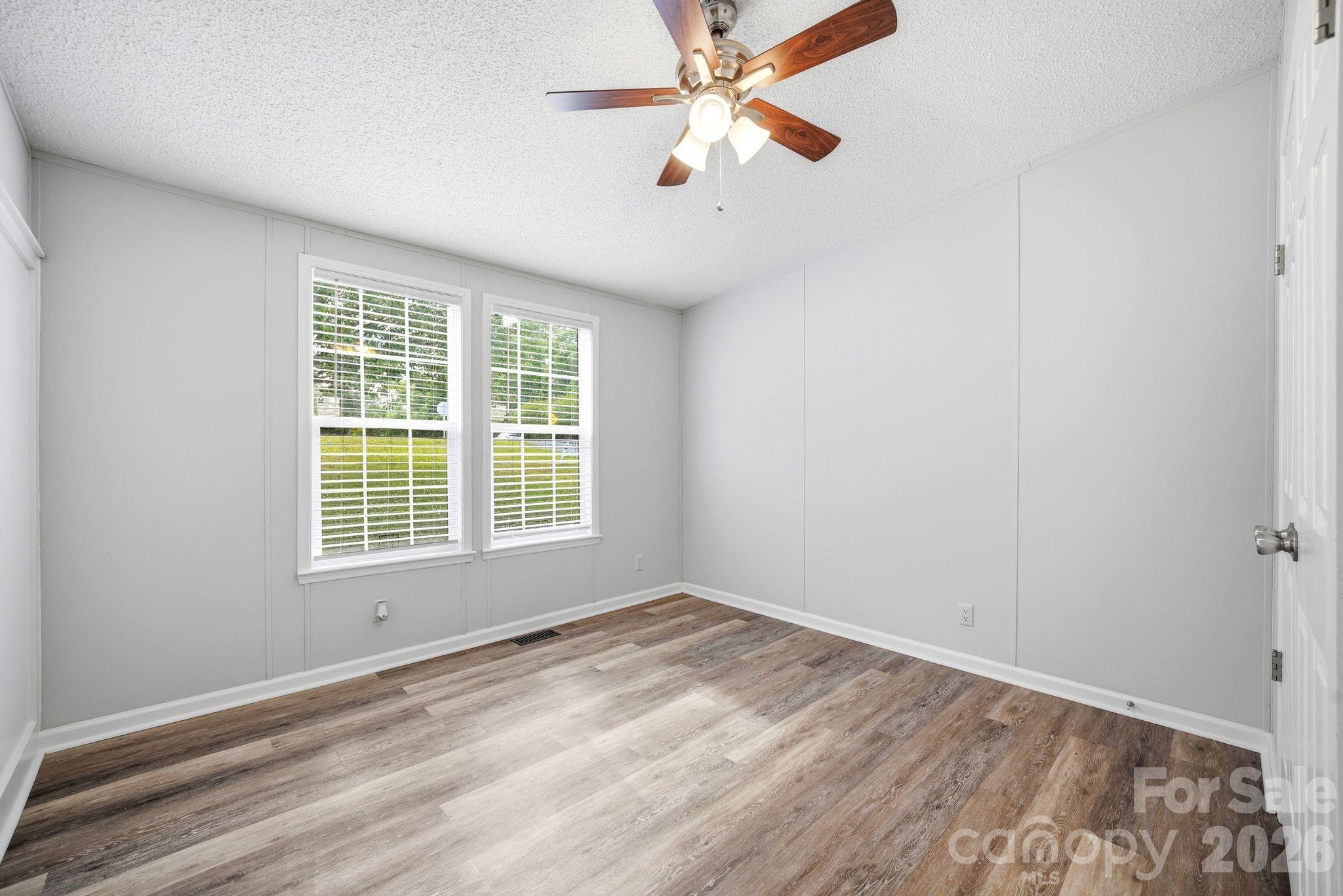 2368 Beth Haven Church Road Denver, NC 28037 - Photo 28 of 42 a view of empty room with wooden floor and fan