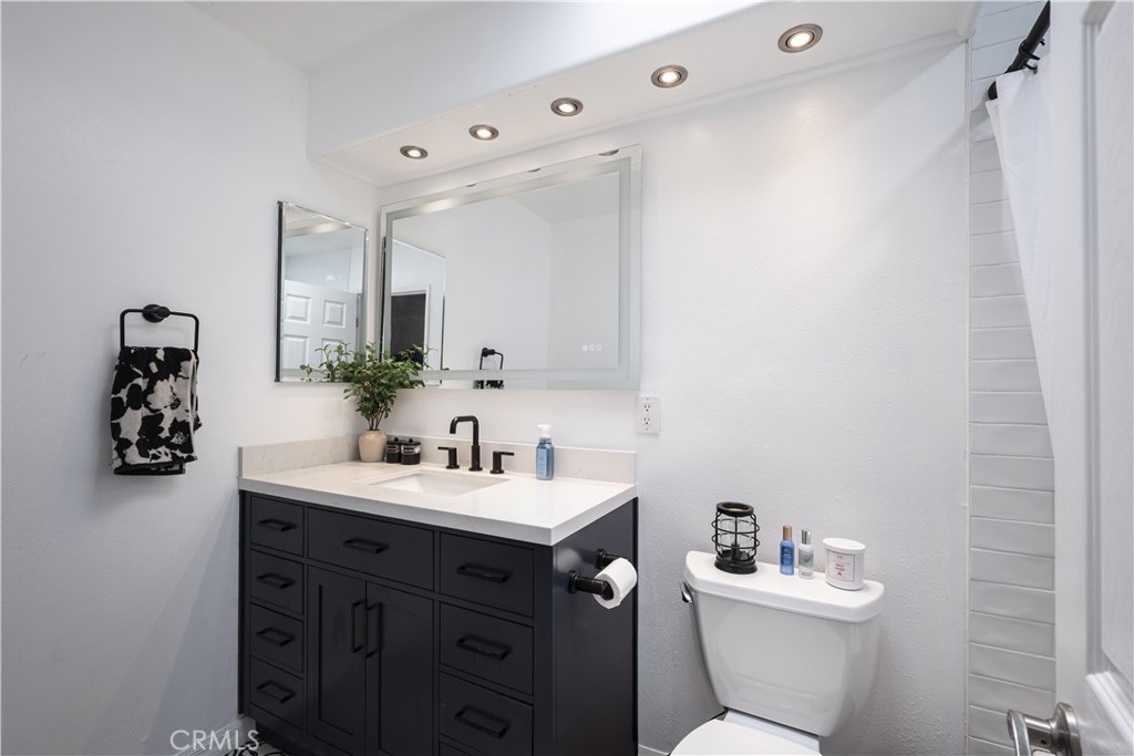 2203 Homewood Avenue Simi Valley, CA 93063 - Photo 25 of 37 a bathroom with a toilet sink and mirror