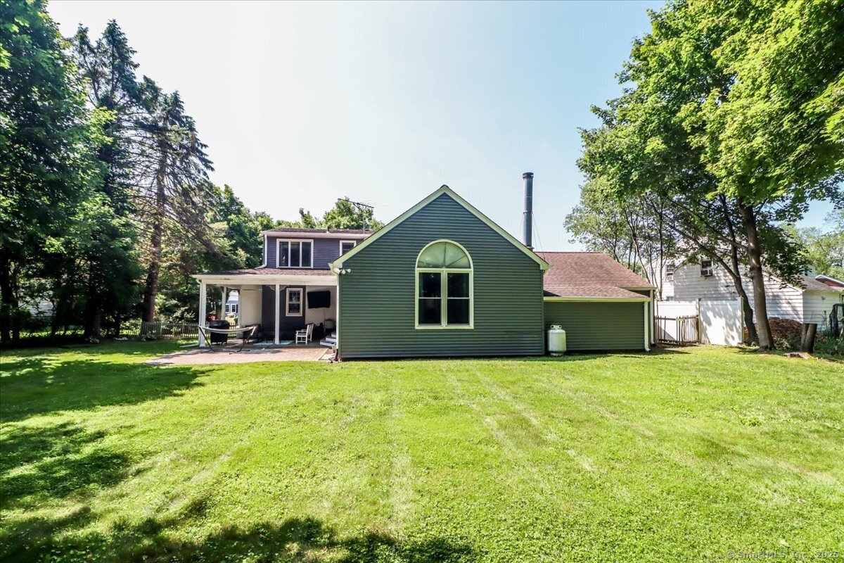 a front view of house with yard and trees