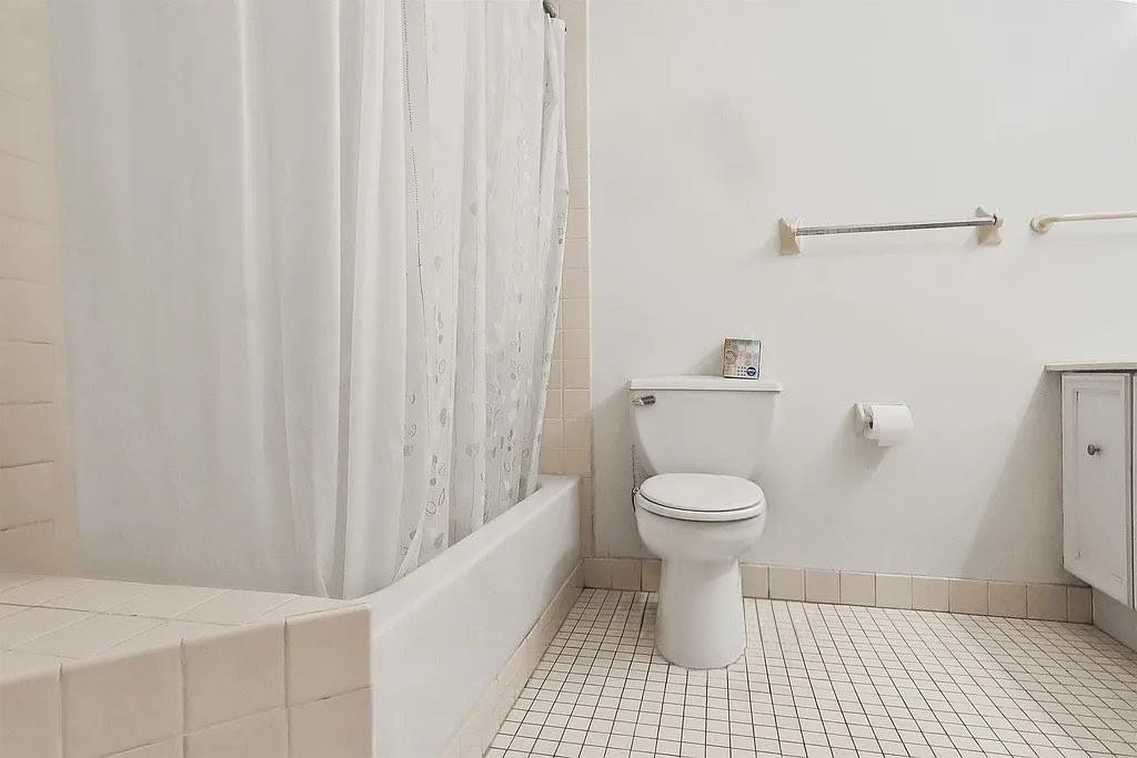 401 Harmon Cove Tower, Unit 401 Secaucus, NJ 07094 - Photo 20 of 49 a bathroom with a toilet and a shower
