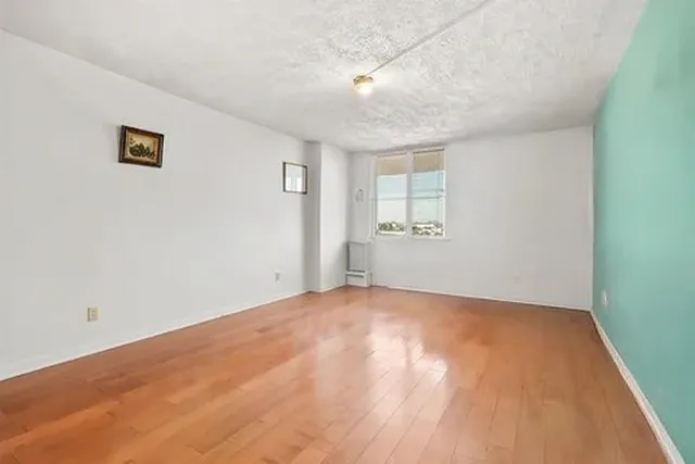 a view of an empty room with a window