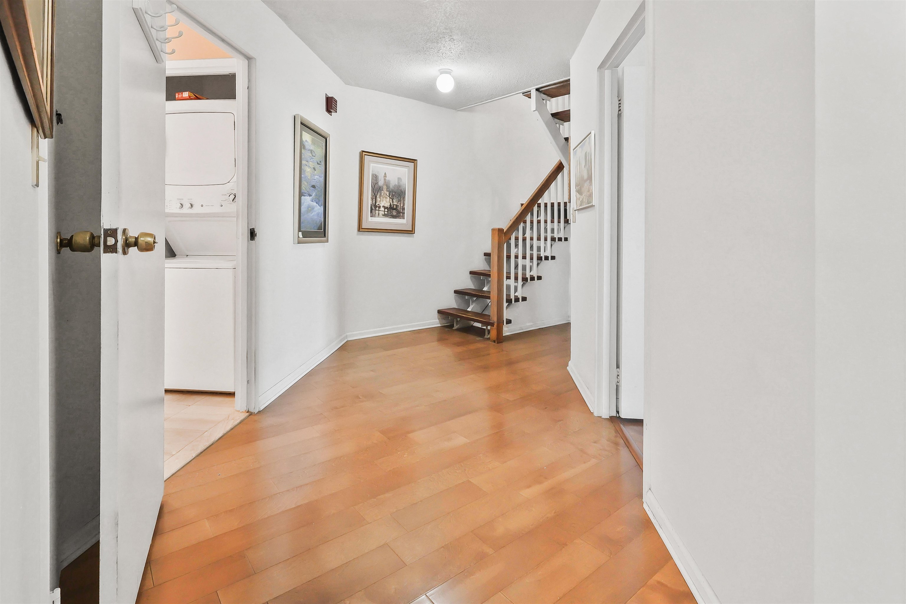 401 Harmon Cove Tower, Unit 401 Secaucus, NJ 07094 - Photo 30 of 49 a view of a hallway with wooden floor and staircase