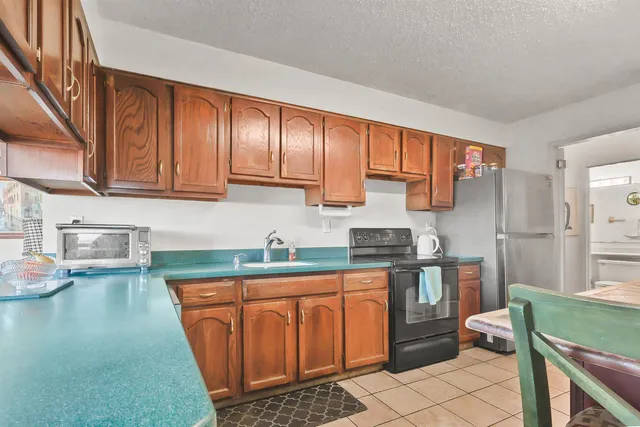 a kitchen with stainless steel appliances granite countertop a sink stove and cabinets