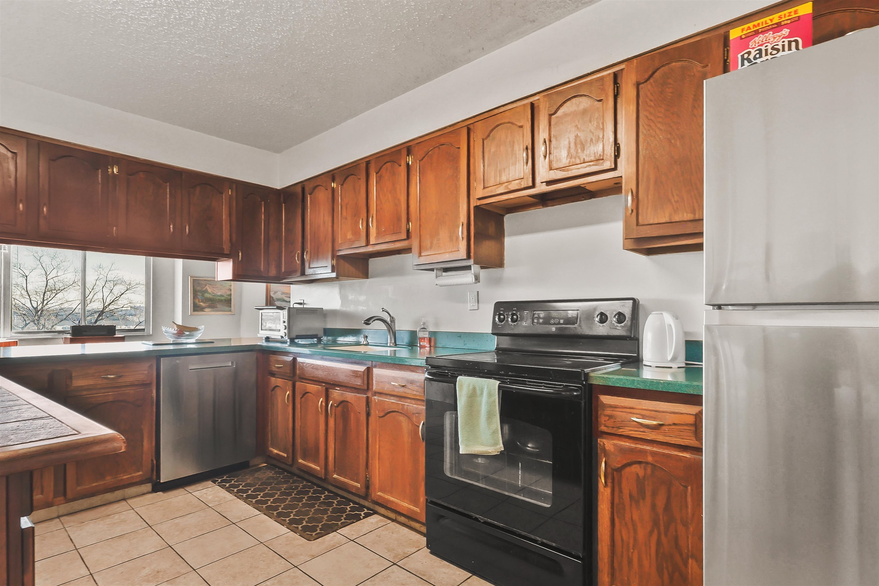 401 Harmon Cove Tower, Unit 401 Secaucus, NJ 07094 - Photo 9 of 49 a kitchen with stainless steel appliances granite countertop a stove top oven a sink dishwasher and a refrigerator with wooden cabinets