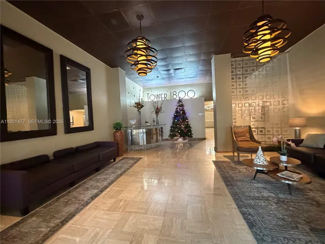 a lobby with furniture and rug